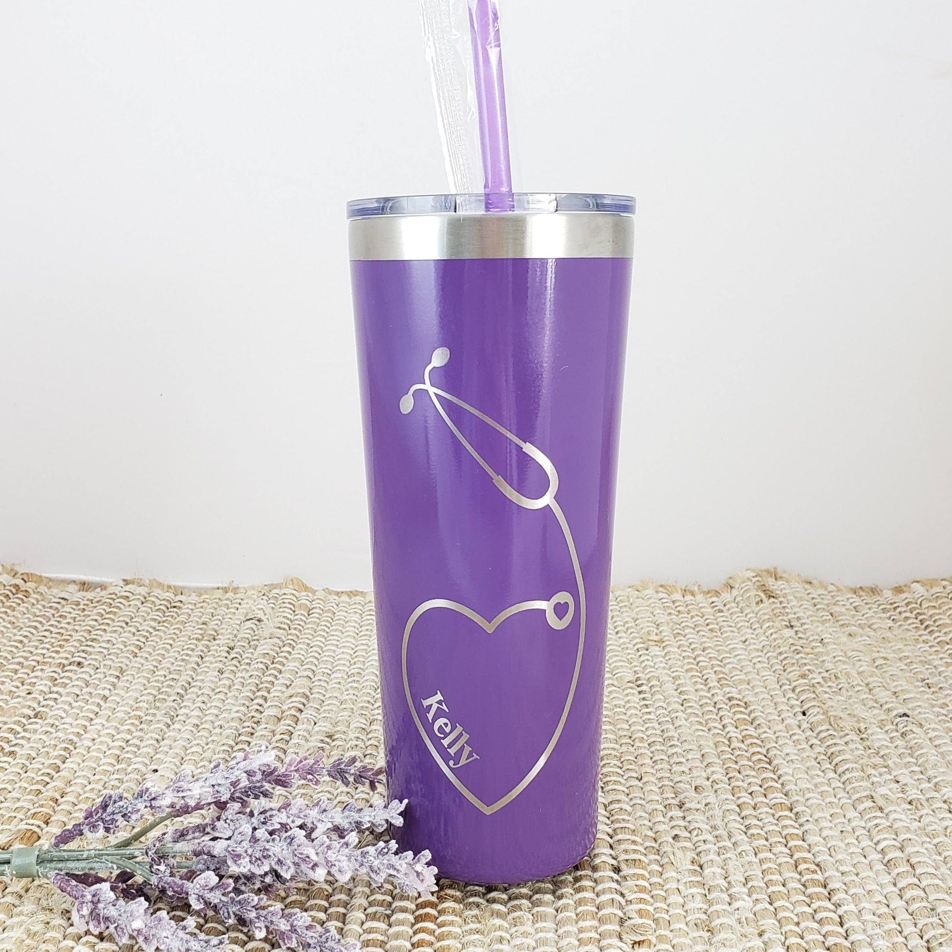https://candywrapperstore.com/cdn/shop/files/nurse-heart-stethoscope-engraved-tumbler-with-name-on-front-double-wall-insulated-tumbler-with-clear-slider-lid-colored-straw-35758606319774.jpg?v=1691049734&width=1946